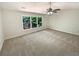 A large bedroom with a ceiling fan and a large window that lets in plenty of natural light at 6370 Maid Marion Close, Alpharetta, GA 30005