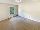 A bedroom with neutral paint and carpet and a single window at 6370 Maid Marion Close, Alpharetta, GA 30005
