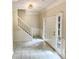Entryway foyer with staircase featuring tile floors, white trim, and great natural light at 6370 Maid Marion Close, Alpharetta, GA 30005