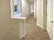 Upstairs hallway featuring neutral carpet leading to bedrooms at 6370 Maid Marion Close, Alpharetta, GA 30005