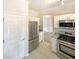 Well-lit kitchen featuring stainless steel appliances and white cabinets at 6370 Maid Marion Close, Alpharetta, GA 30005