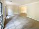 Spacious living room with large windows and neutral carpet at 6370 Maid Marion Close, Alpharetta, GA 30005