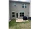 Backyard patio area with new gray vinyl siding and green grass at 6780 Cedar Glen Rd, Peachtree Corners, GA 30360