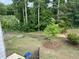 A verdant backyard featuring a manicured lawn and natural wooded backdrop offers a private and serene outdoor space at 6780 Cedar Glen Rd, Peachtree Corners, GA 30360