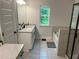 Bathroom features a double sink vanity, a shower with black trim, and a window offering a backyard view at 6780 Cedar Glen Rd, Peachtree Corners, GA 30360