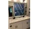 Bathroom featuring a double sink vanity with granite countertop and blue decorative painted wall at 6780 Cedar Glen Rd, Peachtree Corners, GA 30360