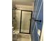 Bathroom featuring a tiled shower with a glass door and blue decorative painted wall at 6780 Cedar Glen Rd, Peachtree Corners, GA 30360