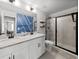 Bright bathroom featuring double sinks, quartz counters, tiled shower with glass door, and modern fixtures at 6780 Cedar Glen Rd, Peachtree Corners, GA 30360