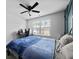 Cozy bedroom featuring a blue comforter, corner desk, and a window with natural light at 6780 Cedar Glen Rd, Peachtree Corners, GA 30360