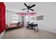 Versatile bedroom featuring a black desk, pink love seat, and charming floral decor at 6780 Cedar Glen Rd, Peachtree Corners, GA 30360