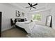 Neutral bedroom showcasing a tray ceiling, queen bed, large window, and elegant decor at 6780 Cedar Glen Rd, Peachtree Corners, GA 30360