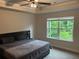 Relaxing bedroom with a large window offering a serene view of lush greenery at 6780 Cedar Glen Rd, Peachtree Corners, GA 30360