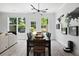 Bright dining room with a stylish black table and modern lighting fixture, next to a wall with an illustrative world map at 6780 Cedar Glen Rd, Peachtree Corners, GA 30360