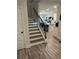 Entryway with hardwood floors, a staircase, and an open view into the living room at 6780 Cedar Glen Rd, Peachtree Corners, GA 30360
