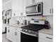 A modern kitchen features white cabinets, subway tile backsplash, and stainless steel appliances at 6780 Cedar Glen Rd, Peachtree Corners, GA 30360