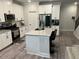 Modern kitchen features stainless steel appliances, white cabinets, and granite countertops at 6780 Cedar Glen Rd, Peachtree Corners, GA 30360