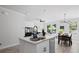 Bright kitchen featuring granite counters, stainless steel dishwasher, and an island sink with a sleek black faucet at 6780 Cedar Glen Rd, Peachtree Corners, GA 30360