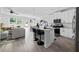 Open-concept kitchen featuring white cabinets, a large island, stainless steel appliances, and hardwood floors at 6780 Cedar Glen Rd, Peachtree Corners, GA 30360