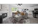 Inviting living area featuring a fireplace, modern sectional couch, and an open transition to the dining and kitchen at 6780 Cedar Glen Rd, Peachtree Corners, GA 30360