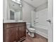Bathroom featuring a shower and bathtub combination, a toilet, and wood-colored cabinets at 1020 Broadview Dr, Marietta, GA 30062