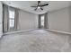 Bedroom features a ceiling fan, carpet, two windows, and neutral walls at 1020 Broadview Dr, Marietta, GA 30062