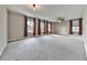 Large, versatile bonus room with neutral carpet, a ceiling fan, and three windows at 1020 Broadview Dr, Marietta, GA 30062