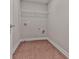 Empty laundry room with hookups, a storage shelf and vinyl wood floor at 1020 Broadview Dr, Marietta, GA 30062