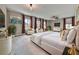 Bright main bedroom with a white platform bed, decorative pillows, and floor-to-ceiling curtains at 1020 Broadview Dr, Marietta, GA 30062