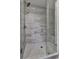Shower with marble patterned tiles and a glass enclosure that provides an updated look at 1020 Broadview Dr, Marietta, GA 30062