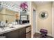 This well-appointed wet bar features modern appliances, glass shelving, and stylish lighting at 3192 Paces Mill Rd, Atlanta, GA 30339