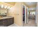 Bathroom with granite countertop, vanity, modern lighting and doorway to walk-in closet at 3192 Paces Mill Rd, Atlanta, GA 30339
