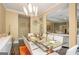 Elegant dining room with modern chandelier, glass table, hardwood floors, and seating for eight at 3192 Paces Mill Rd, Atlanta, GA 30339