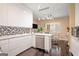 Sleek modern kitchen with white cabinetry, marble countertops, and a breakfast area at 3192 Paces Mill Rd, Atlanta, GA 30339