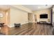 Open-plan living room with hardwood flooring, a large screen TV and plenty of light at 3192 Paces Mill Rd, Atlanta, GA 30339
