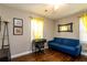 Spare bedroom or office featuring a desk, blue couch, and natural light at 3224 Canary Ct, Decatur, GA 30032