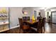 The dining room has wood floors, dark wood table and chairs, with shelving and stainless steel fridge nearby at 3224 Canary Ct, Decatur, GA 30032