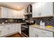 Updated kitchen boasting granite countertops, stainless steel appliances, and decorative tile backsplash at 3224 Canary Ct, Decatur, GA 30032