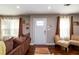 Cozy living room features hardwood floors, neutral paint, and a comfortable sofa with a view of the front yard at 3224 Canary Ct, Decatur, GA 30032