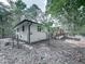 A partial rear view of a ranch-style home in a wooded setting at 221 Wonewok Dr, Canton, GA 30114