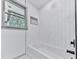 This bathroom showcases a tub with tiled walls and accent art at 221 Wonewok Dr, Canton, GA 30114