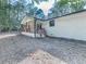 Side view of a bright white brick home with a charming covered porch and wooded surroundings at 221 Wonewok Dr, Canton, GA 30114
