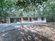 Charming ranch-style home with a freshly painted exterior, mature trees, and a covered porch at 221 Wonewok Dr, Canton, GA 30114