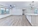 Modern open floor plan with hardwood floors, a kitchen island, and tons of natural light at 221 Wonewok Dr, Canton, GA 30114