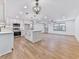Open concept living room and kitchen with hardwood floors and lots of natural light at 221 Wonewok Dr, Canton, GA 30114