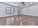 Well-lit living room featuring new hardwood floors, a ceiling fan, and updated door and window trim at 221 Wonewok Dr, Canton, GA 30114