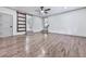 Modern living room featuring hardwood floors, a ceiling fan, and two doors and a sliding door at 221 Wonewok Dr, Canton, GA 30114