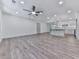 Open-concept living room with hardwood floors, a ceiling fan, and access to a modern kitchen at 221 Wonewok Dr, Canton, GA 30114