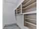 Walk-in pantry with custom built in wooden shelving for storage, and wood look tile floors at 221 Wonewok Dr, Canton, GA 30114