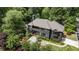 Captivating aerial view of a dark painted luxury home surrounded by lush greenery and professional landscaping at 320 Shady Grove Ln, Alpharetta, GA 30009