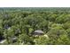 An aerial view shows a secluded home nestled among trees, offering privacy and natural beauty at 320 Shady Grove Ln, Alpharetta, GA 30009